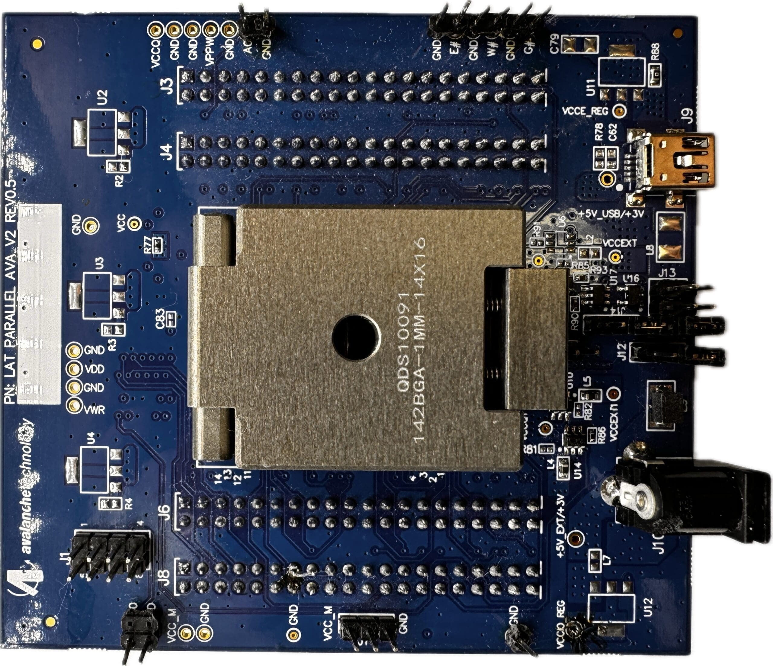 Blue circuit board with various components.